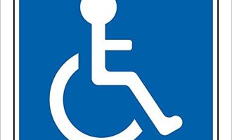 A blue sign with a white accessibility symbol. It shows a seated person in a wheelchair.