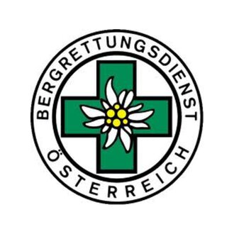A logo of the Austrian Mountain Rescue Service. It features a green cross with an alpine flower in the center. | © Bergrettung Mittelberg Hirschegg Logo