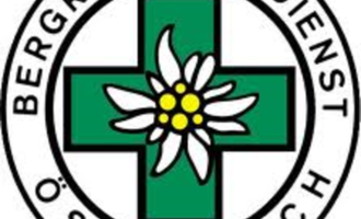 Ein Logo des Bergrettungsdienstes Österreich. Es zeigt ein grünes Kreuz mit einer Alpenblume in der Mitte.