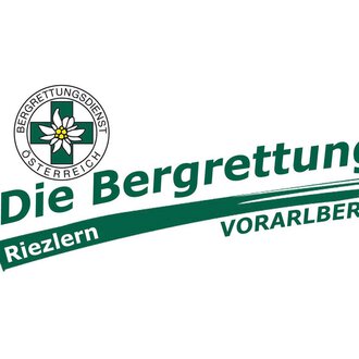 Das Bild zeigt das Logo des Bergrettungsdienstes Österreich. Es ist mit den Worten "Die Bergrettung Riezlern Vorarlberg" sowie einem Emblem mit einer Blume gestaltet. | © Bergrettung Vorarlberg