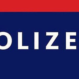 A police sign with the word "POLICE" in large letters. It is in the colors blue and red.