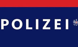 A police sign with the word "POLICE" in large letters. It is in the colors blue and red.