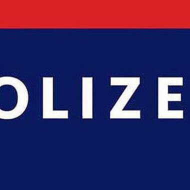 A police sign with the word "POLICE" in large letters. It is in the colors blue and red.