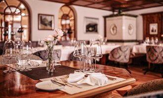 Ein elegantes Restaurant mit schön gedeckten Tischen und stilvoller Einrichtung. Sanfte Beleuchtung und dekorative Elemente schaffen eine einladende Atmosphäre. | © Hotel Birkenhöhe | Sascha Gast