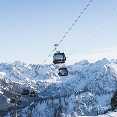 Seilbahn unterhalb des Gipfels im Schnee mit Bergketten im Hintergrund | © Oberstdorf · Kleinwalsertal Bergbahnen Fotograf: Maja Eifert